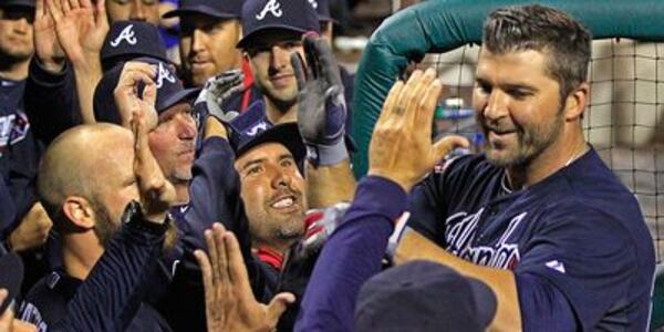 Dan Uggla celebrates with teammates after ninth-inning grand slam Monday. (AP photo)