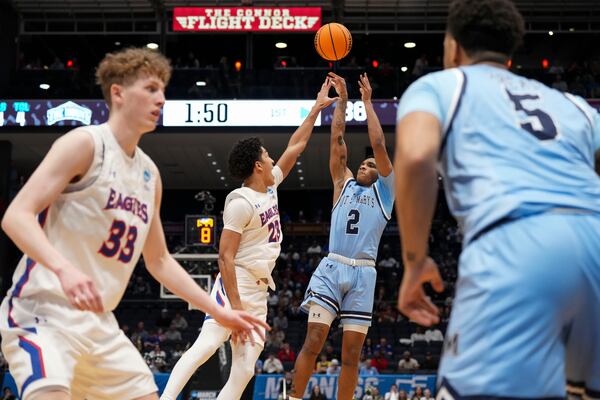 Mount St. Mary's guard Arlandus Keyes (2) shoots against American University forward Greg Jones (23) during the first half of a First Four college basketball game in the NCAA Tournament, Wednesday, March 19, 2025, in Dayton, Ohio. (AP Photo/Jeff Dean)