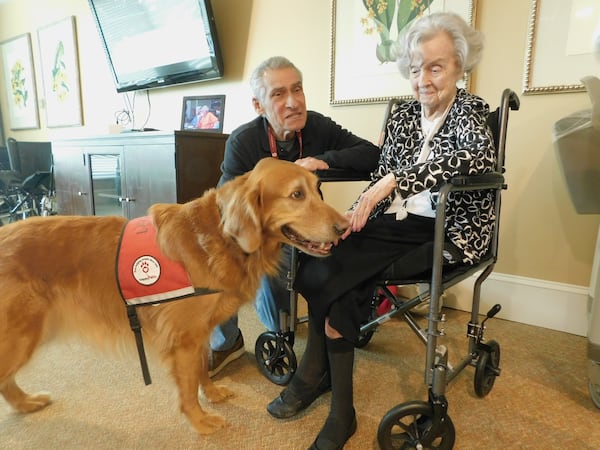 Happy Tails volunteer Howard Shore introduces his veteran therapy dog Leo to Helen Fagan, a resident at Lenbrook senior community. Photo contributed by Lenbrook.