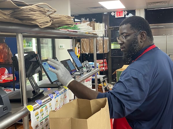 VFC Kitchens chief technology officer Bryan Shaw uses smart tablets to monitor food orders from various third-party delivery platforms. Ligaya Figueras/ligaya.figueras@ajc.com