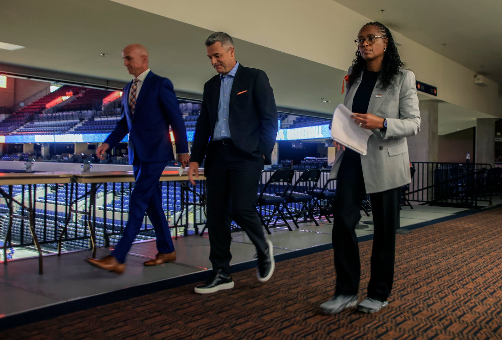 Virginia NCAA college basketball head coach Tony Bennett is flanked by Erich Bacher, Associate Athletic Director for Athletic Communications, left, and Athletic Director Carla Williams before a press conference in Charlottesville, Va., Friday, Oct. 18, 2024. (Cal Cary/The Daily Progress via AP)