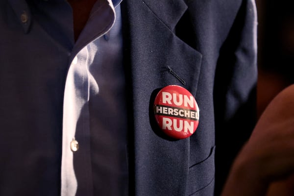 A supporter wears a “Run Herschel Run” button in support of Herschel Walker at the candidate's party Tuesday at the Georgian Terrace Hotel in Atlanta to celebrate his win in the GOP's U.S. Senate primary. Walker will face U.S. Sen. Raphael Warnock, a Democrat, in November. (Jason Getz / Jason.Getz@ajc.com)