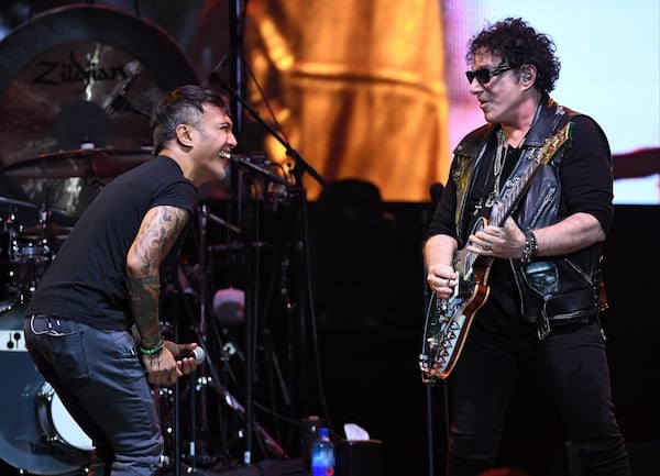 Singer Arnel Pineda (L) and  Neal Schon of Journey rock out a tune in Las Vegas. (Photo by Ethan Miller/Getty Images)