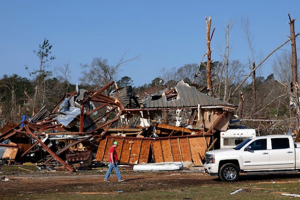 Residents look for personal belongings in the damage after a tornado passed through where two people lost their lives, Sunday, March 16, 2025, in Plantersville, Ala. (AP Photo/Butch Dill)