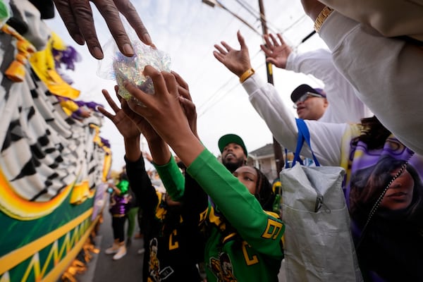 Revelers vie for throws during the Krewe of Zulu parade on Mardi Gras Day, Tuesday, March 4, 2025 in New Orleans. (AP Photo/Gerald Herbert)