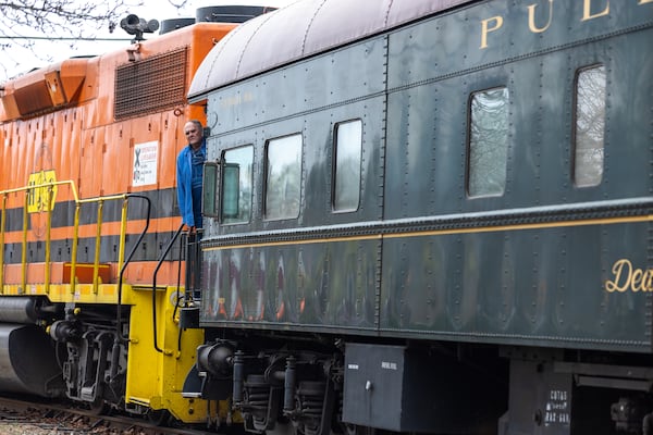 A person stands on the SAM Shortline excursion train in downtown Plains on Saturday, February 25, 2023. (Arvin Temkar / arvin.temkar@ajc.com)