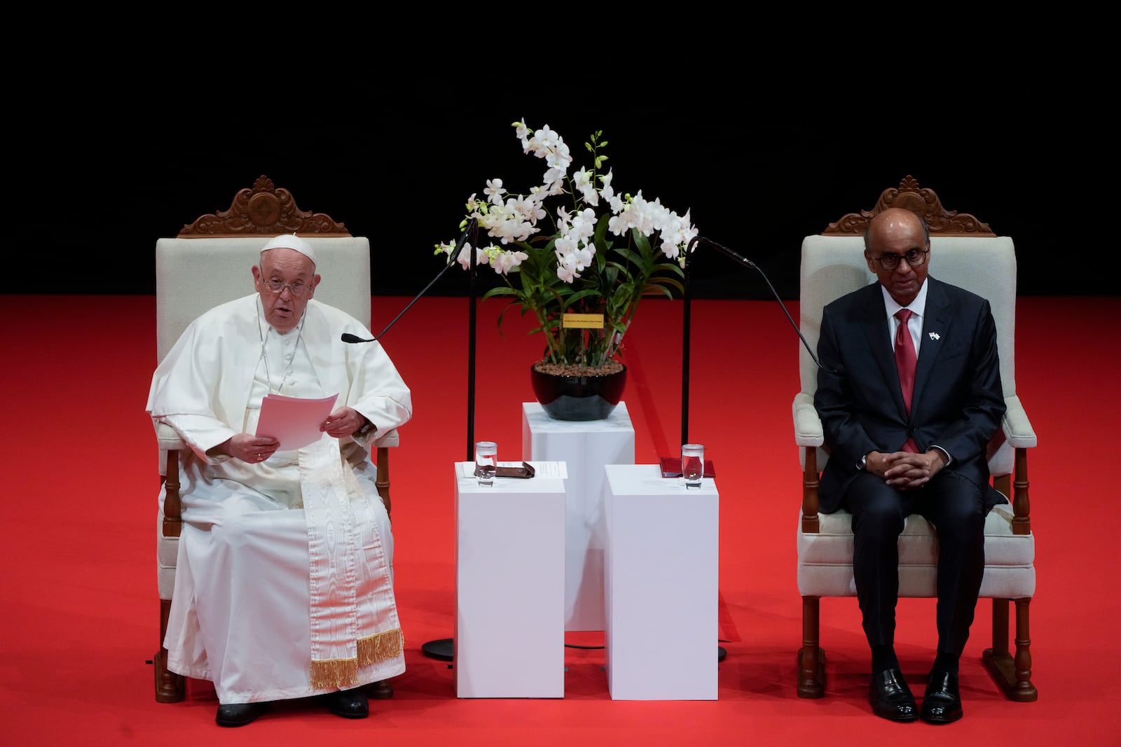 Pope Francis addresses Singapore's President Tharman Shanmugaratnam, right, and the audience during a meeting with the authorities, civil society and the diplomatic corps in the theatre of the Cultural Centre of the National University of Singapore, Thursday, Sept. 12, 2024. Pope Francis flew to Singapore on Wednesday for the final leg of his trip through Asia, arriving in one of the world's richest countries from one of its poorest after a record-setting final Mass in East Timor. (AP Photo/Gregorio Borgia)