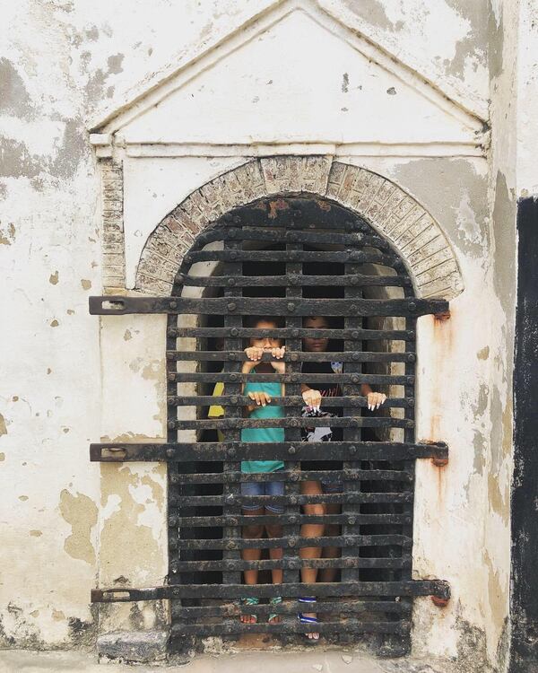 Korleki Kisseih and Audri Kisseih were taken to Ghana for the first time earlier this month by their Ghana-born father Nena Kisseih to mark Korleki’s 14th birthday. The sisters stand behind an iron gate in one of the Elmina Castle dungeons, which would have been used to hold captured Africans bound for slavery.