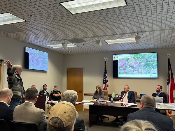 Bartow County commissioner, Steve Taylor, listens to residents who oppose the granite quarry in the former Pine Log wildlife management area at the Cartersville townhouse on Jan. 8.