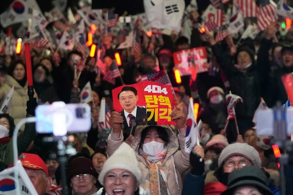 Supporters of impeached South Korean President Yoon Suk Yeol stage a rally to oppose his impeachment near the presidential residence in Seoul, South Korea, Saturday, March 8, 2025. The letters read "Dismiss Impeachment." (AP Photo/Ahn Young-joon)