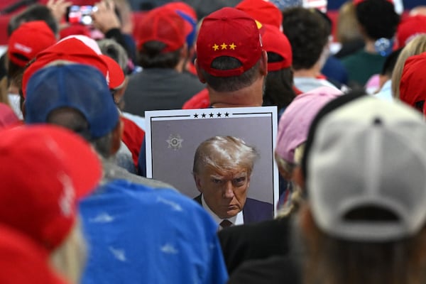 A supporter holds a sign during a rally at the Georgia State University’s convocation center on Saturday, August 3, 2024 in Atlanta. Former President Donald Trump and Vice-Presidential candidate JD Vance are holding their first rally together in Georgia on Saturday at the same place – the GSU Convocation Center- Kamala Harris held hers earlier this week.  (Hyosub Shin / AJC)