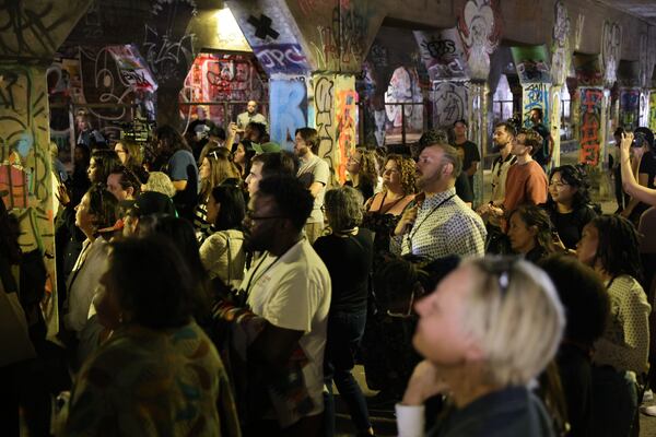 A crowd listens as The Spelman Glee Club performs inside Krog Street Tunnel on Thursday, March 7, 2024. The performance is part of the Creative Placemaking Summit taking place in Atlanta from March 5-8. (Natrice Miller/ Natrice.miller@ajc.com)