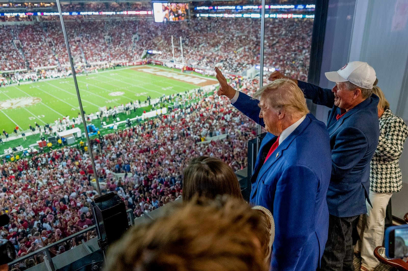 Former President Donald Trump, the Republican presidential nominee, waves during the Georgia vs. Alabama football game Saturday at Bryant-Denny Stadium, in Tuscaloosa, Ala. (Doug Mills/The New York Times)