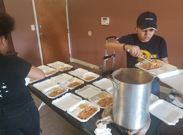 EZET youth prepare meals for needy Atlanta residents during a recent community outreach effort. CONTRIBUTED / ALEX HARRIS