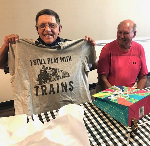 At his retirement party, David Dressler, 75, receives a t-shirt noting his favorite hobby. Dressler worked at the CDC for 53 years and is one of the longest serving employees at the agency.