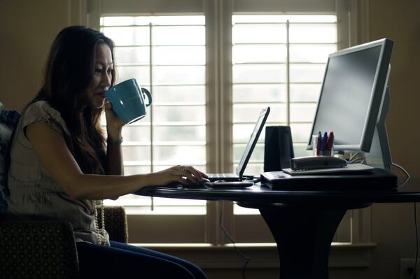 Denise Kenson-Liu works from her Snellville home one day a week for her job with the IT department of Gwinnett County on Fri, Feb.18, 2011. Bob Andres bandres@ajc.com