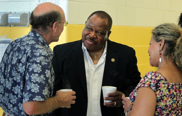 DeKalb County Commissioner Stan Watson, center, talks with Robert Pegel, of Decatur, left, and Debra DeBerry, right, during his community breakfast on June 4, 2011. Photo by Jason Getz