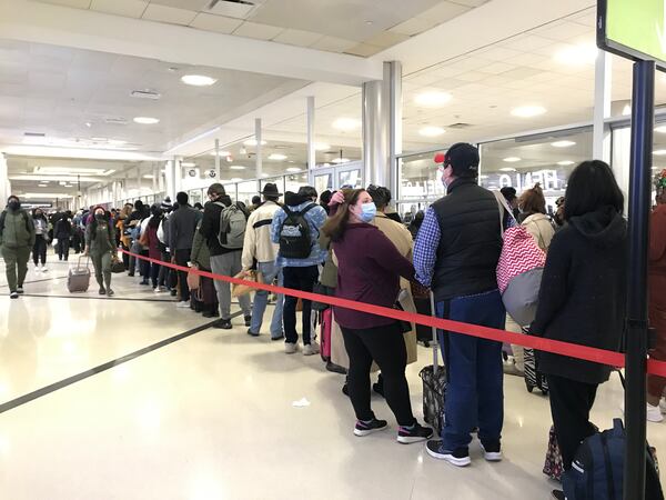 Lines for security screening at the North checkpoint in the domestic terminal at Hartsfield-Jackson International Airport stretched out of the queueing area and down the hallway early Wednesday morning.