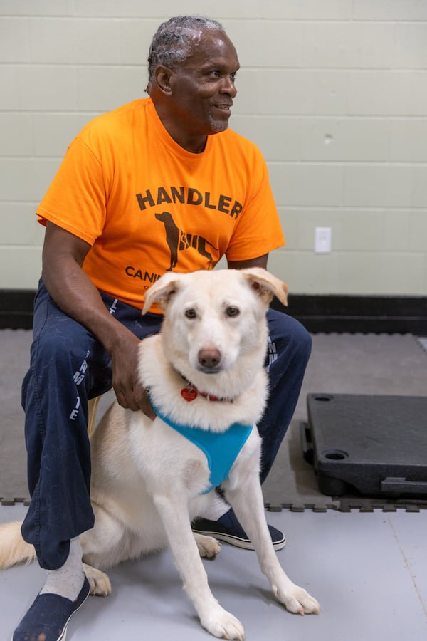 Roosevelt Micher Jr. takes care of his dog, Merrell.