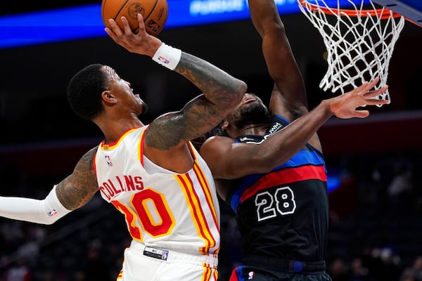 Atlanta Hawks forward John Collins (20) attempts a dunk as Detroit Pistons center Isaiah Stewart (28) defends during the first half of an NBA basketball game, Wednesday, Oct. 26, 2022, in Detroit. (AP Photo/Carlos Osorio)