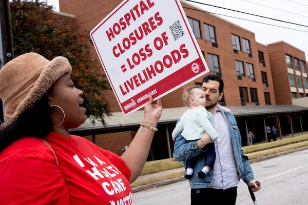 Protestors, including Dom Kelly, a father with cerebral palsy, march to expand access to Medicaid in Georgia in front of Wellstar's Atlanta Medical Center which used to be an Emory Hospital before it was shut down years ago in Atlanta on Sunday, November 12, 2023. (Olivia Bowdoin for The Atlanta Journal-Constitution)