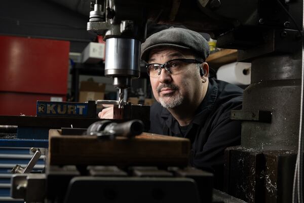 Dan Parker in his Columbus, Ga machine shop. Totally blind following a race car crash in 2013, Parker uses specially-adapted tools to create all-metal pens that he sells worldwide. Parker, who attended the Synergies Work EDDIE Awards, was featured in the gala's opening video. He credits the non-profit for helping him grow his business.  (Robin Rayne  for Zuma Press )