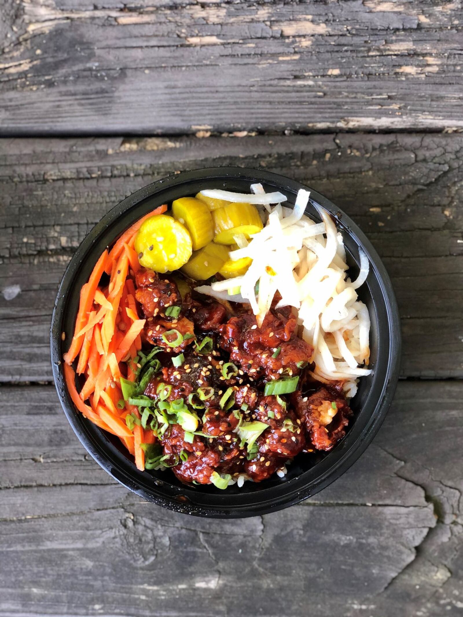 The Korean fried chicken bowl from Whiskey Bird came drenched in a sweet sauce and paired with sushi rice and pickled veggies. CONTRIBUTED BY WENDELL BROCK