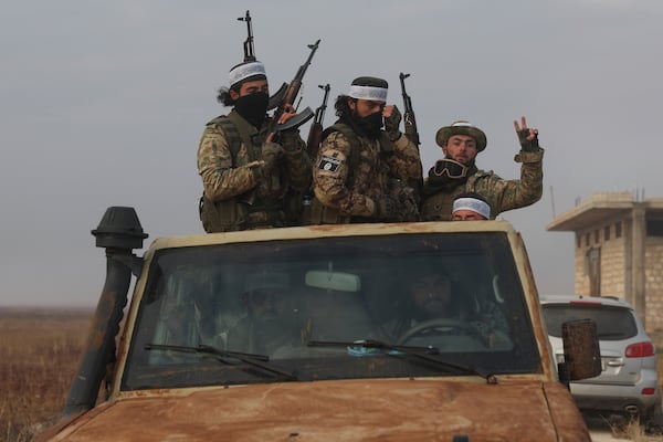 Syrian opposition fighters ride in a truck in Talhiya, Idlib countryside, Syria, Friday, Nov. 29, 2024. (AP Photo/Ghaith Alsayed)