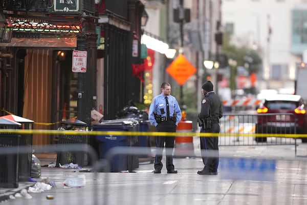 Emergency services attend the scene on Bourbon Street after a vehicle drove into a crowd on New Orleans' Canal and Bourbon Street, Wednesday Jan. 1, 2025. (AP Photo/Gerald Herbert)