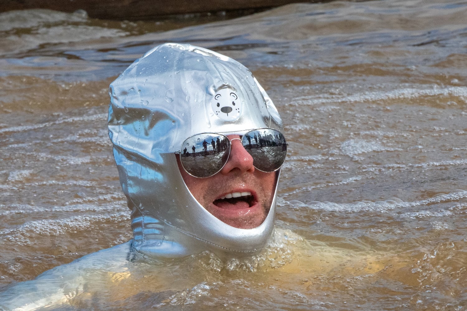 John Collins looks to get to the dock as he participates in the 26th annual Polar Bear Paddle and Plunge at Lake Lanier Olympic Park on Monday, Jan 1, 2024.  There is a category of best costume in the event, as well as best splash and fastest exit from the lake. (Jenni Girtman for The Atlanta Journal-Constitution)