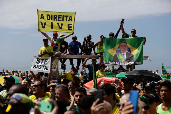 Supporters of Brazil's former President Jair Bolsonaro take part in a rally on Copacabana Beach in support of a proposed bill to grant amnesty to those arrested for storming government buildings in an alleged coup attempt in 2023, in Rio de Janeiro, Sunday, March 16, 2025. (AP Photo/Bruna Prado)