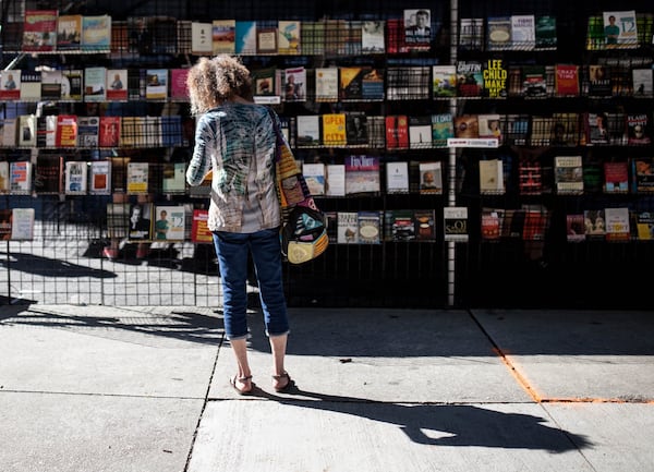 A woman reads a book at the 12th Annual AJC Decatur Book Festival last year. CONTRIBUTED BY BRANDEN CAMP