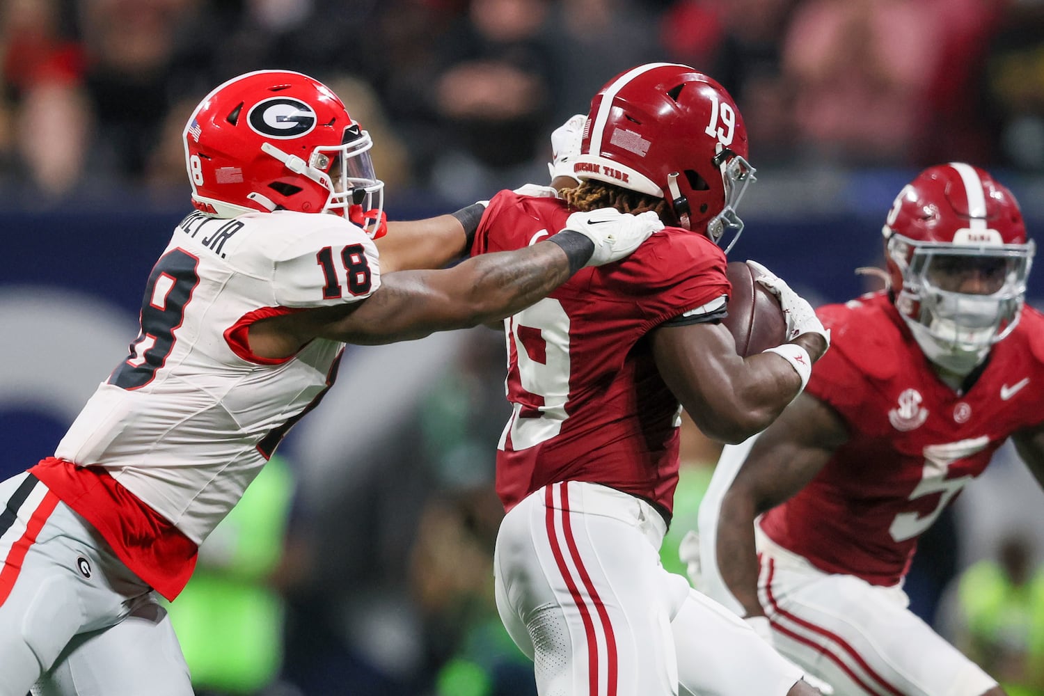 Georgia Bulldogs linebacker Xavian Sorey Jr. (18) brings down Alabama Crimson Tide wide receiver Kendrick Law (19) during the second half of the SEC Championship football game at the Mercedes-Benz Stadium in Atlanta, on Saturday, December 2, 2023. (Jason Getz / Jason.Getz@ajc.com)