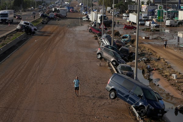 Vehicles are seen piled up after being swept away by floods on a motorway in Valencia, Spain, Thursday, Oct. 31, 2024. (AP Photo/Manu Fernandez)