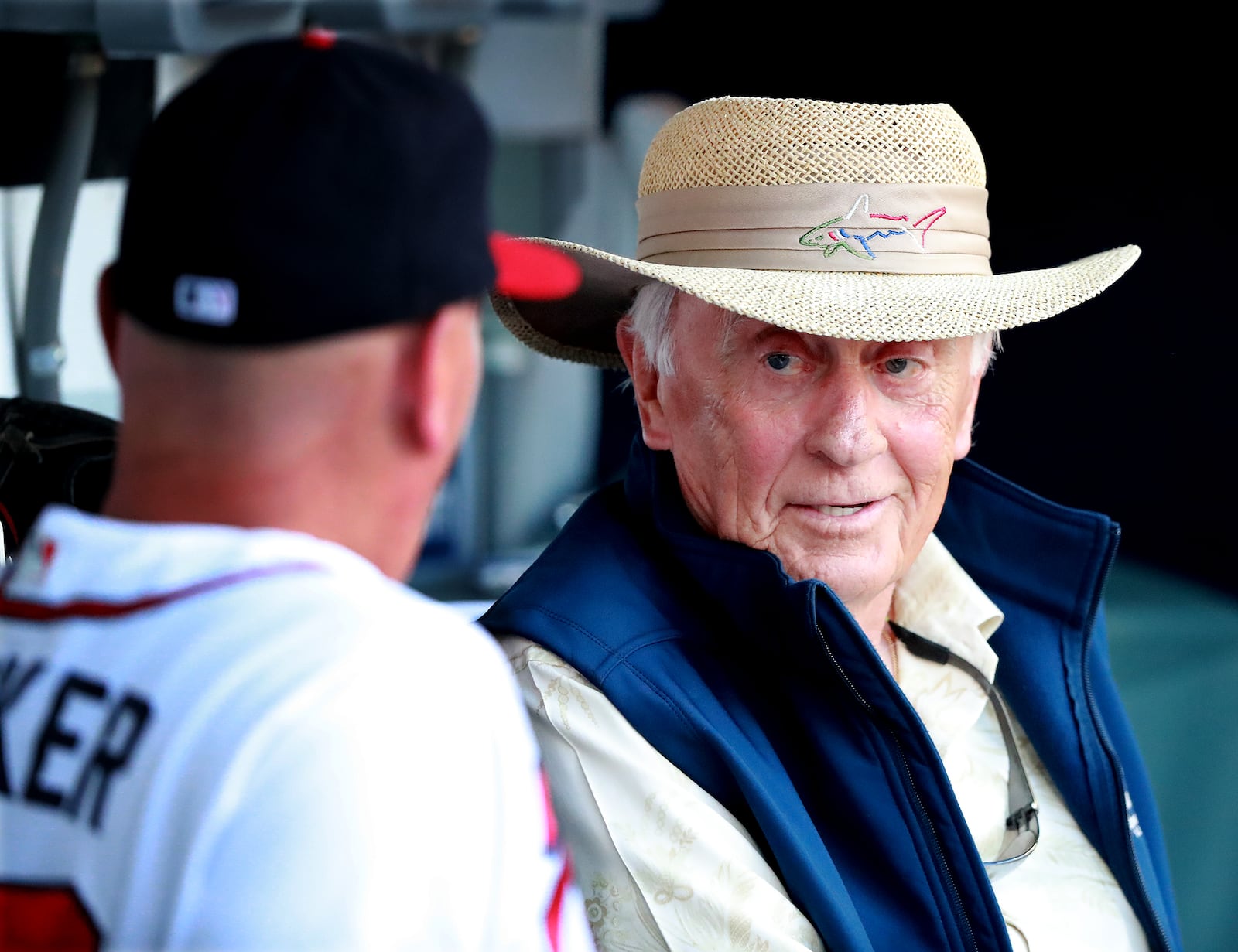 Braves great Phil Niekro (right) visits with manager Brian Snitker in the dugout before the game.   Curtis Compton/ccompton@ajc.com