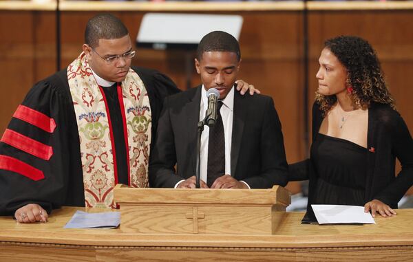 August 28, 2019 - Atlanta - The Rev. Dr. Kevin Murriel (from left), senior pastor at Cascade United Methodist Church in Atlanta, comforts Derrick Lottie Jr. as he delivers his remembrances with Maya Foreman.   A "Celebration of Life" was held for Christopher Redding Edwards II, Erin Victoria Edwards, and their mother, Dr. Marsha Edwards, at Cascade United Methodist.  Dr. Marsha Edwards was accused of the fatal shooting last week.    Bob Andres / robert.andres@ajc.com