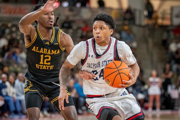 Jackson State guard Daeshun Ruffin, right, dribbles against Alabama State guard Shawn Fulcher (12) during the first half of an NCAA basketball game in the championship of the Southwest Athletic Conference Championship tournament Saturday, March 15, 2025, in College Park, Ga. (AP Photo/Erik Rank)