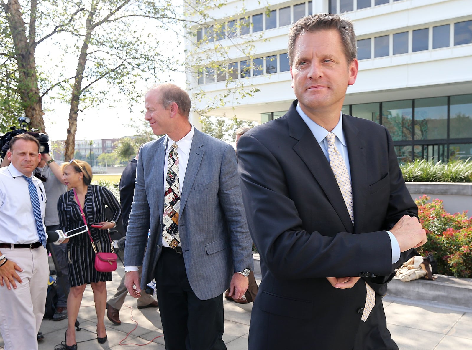 U.S. Attorney John Horn (right) and FBI Special Agent Clifford Goodman (left) brief the news media after Adam Smith pleaded guilty to accepting more than $30,000 in bribes at the Richard B. Russell Federal Building on Tuesday. Curtis Compton/ccompton@ajc.com