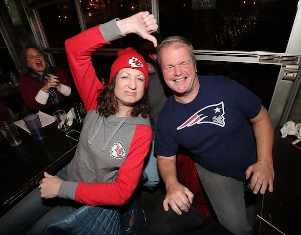 Chiefs fan Becky Taylor and Patriots fan Patrick Hughes face off while watching the AFC Championship game at Midway Pub with a trip to the Super Bowl in Atlanta on the line on Sunday, Jan. 20, 2019, in Atlanta.  (Photo: Curtis Compton/ccompton@ajc.com)