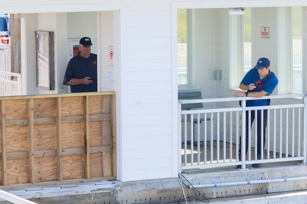 Investigators from engineering firm Wiss, Janney, Elstner Associates take photos on the pier after a gangway collapsed in October, killing seven people and critically injuring three more on Sapelo Island in McIntosh County, Ga. (Miguel Martinez/AJC)