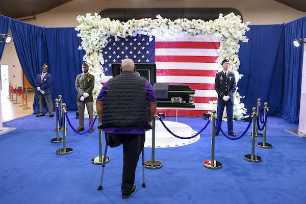 Rudy Solomon stands in front of the casket of Army Reservist Sgt. Kennedy L. Sanders at C.C. McCray City Auditorium, Friday, February 16, 2024, in Waycross, Ga. Sgt. Sanders was killed in a drone attack in late Jan. 28th in Jordan. (Jason Getz / jason.getz@ajc.com)