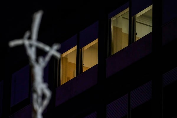 A crucifix is seen in front of the windows of the ward where Pope Francis is hospitalized at the Agostino Gemelli Polyclinic, in Rome, Italy, Sunday, March 2, 2025. (AP Photo/Andrew Medichini)