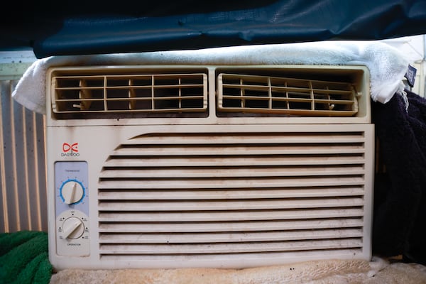 Views of the window air conditioning unit that keeps Patricia Bailey’s bedroom cool shown on Monday, July 17, 2023. Like many homes in Atlanta’s Pittsburgh neighborhood, Bailey’s home does not a central air conditioning system. (Natrice Miller/natrice.miller@ajc.com)