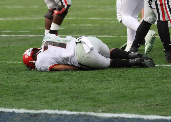 Georgia tailback D'Andre Swift lays on the turf injured after fumbling on a hit by Georgia Tech linebacker David Curry during the third quarter in a NCAA college football game on Saturday, November 30, 2019, in Atlanta. Georgia Tech recovered the fumble.  Curtis Compton/ccompton@ajc.com