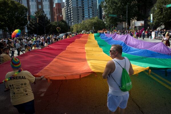 A giant rainbow flag makes its way down Peachtree St. during the Atlanta Pride Parade Sunday in Atlanta GA. October 14, 2018. STEVE SCHAEFER / SPECIAL TO THE AJC