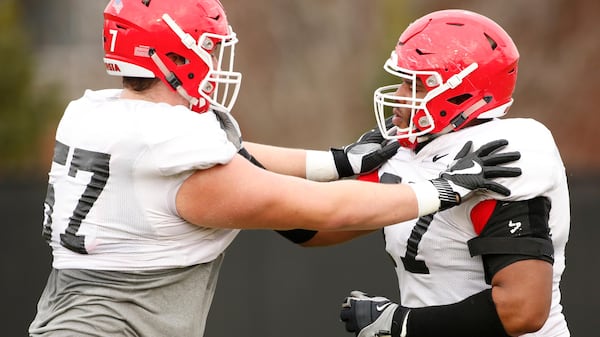 Georgia NCAA college football offensive linemen Daniel Gothard (57) and Isaiah Wynn (77) run a drill during a team practice in Athens, Ga., Monday, Dec. 18, 2017. Georgia faces Oklahoma in the Rose Bowl on Jan. 1, 2018. (Joshua L. Jones/Athens Banner-Herald via AP)