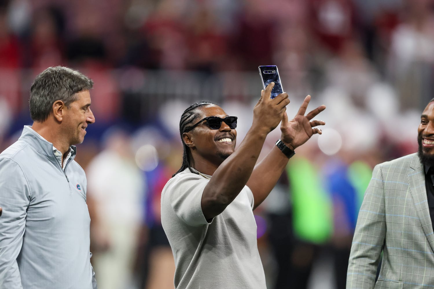 Georgia Bulldogs standout Knowshon Moreno documents the SEC Championship football game against the Alabama Crimson Tide at the Mercedes-Benz Stadium in Atlanta, on Saturday, December 2, 2023. (Jason Getz / Jason.Getz@ajc.com)