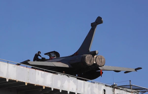 FILE - A French crew member exist from an aircraft on France's nuclear-powered aircraft carrier Charles de Gaulle at Limassol port, Cyprus, Monday, May 10, 2021. (AP Photo/Petros Karadjias, File)