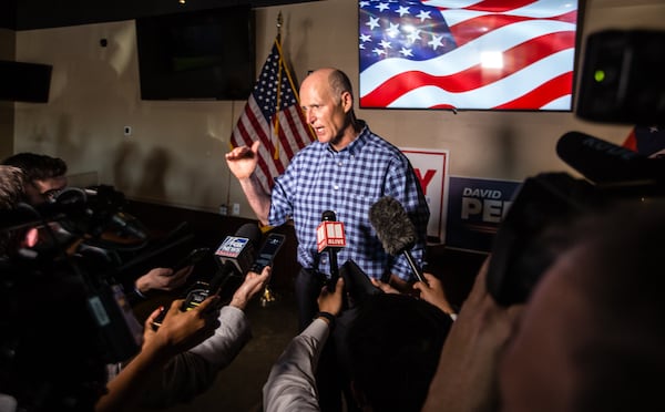 Florida Senator Rick Scott speaks with reporters after the formal rally of support for Senators Kelly Loeffler and David Perdue ends on Friday, November 13, 2020 at Black Diamond Grill in Cumming, GA.  (Jenni Girtman for The Atlanta Journal Constitution)