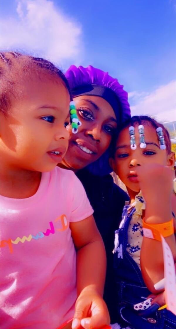 Queene Roux (center) and her 3-year-old daughter (right) were killed in a wreck Wednesday afternoon in Clayton County.